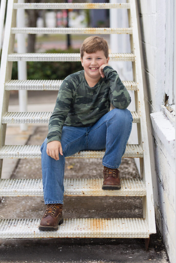 boy sitting on rustic steps